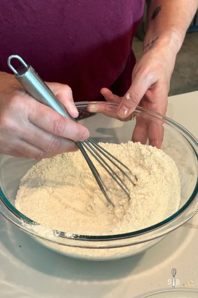 Mixing flour in bowl with whisk